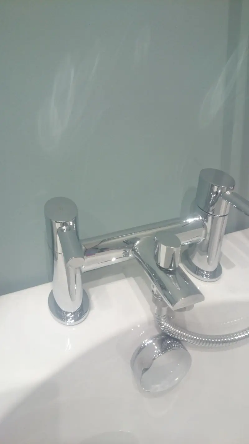 Chrome basin mixer tap fitted on a white basin