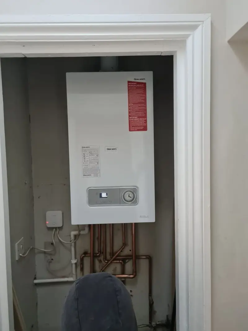 Combi boiler fitted inside a cupboard with new pipework