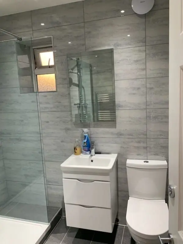 Modern shower room with glass screen, wall-hung basin and toilet