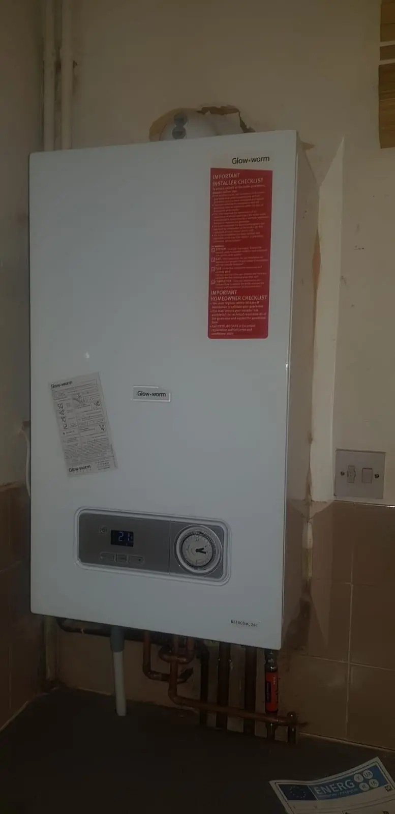 Newly installed combi boiler on a kitchen wall