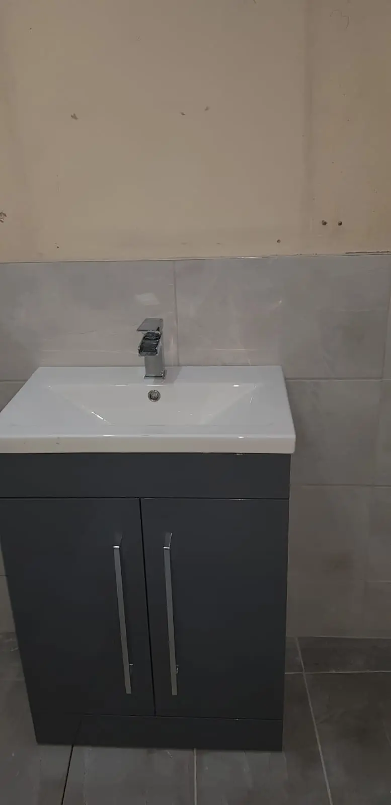 Grey vanity unit with basin and mixer tap