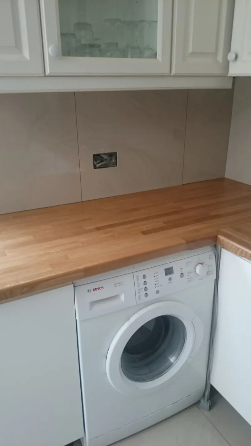 Washing machine plumbed in under a kitchen worktop